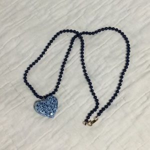 Blue beaded necklace with heart pendant.